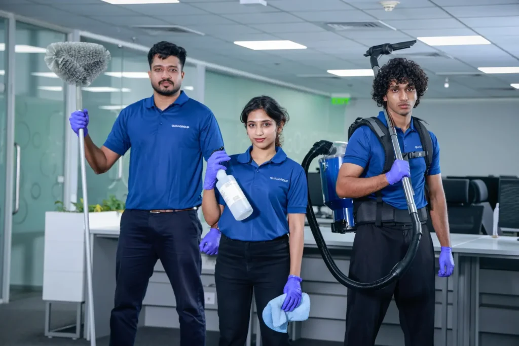 QualGroup cleaner dusting and vacuuming a home through Cleaning